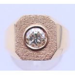 An unmarked gold and yellow diamond gentlemen's ring, the stone spreading to approximately 0.75 ct.