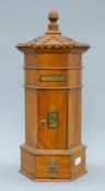A wooden post box. 55 cm high.