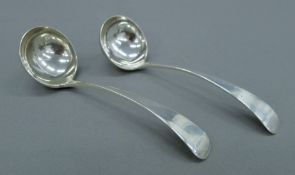 A pair of silver sauce ladles. Each 15 cm long. 89.9 grammes.