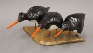 An Albert King wooden sculpture of three oyster catchers. 29.5 cm wide.