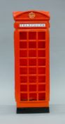 A stick stand formed as a telephone box. 58 cm high.