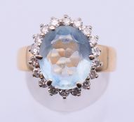 A 14 K gold, diamond and aquamarine ring. Setting 1.5 cm high, ring size R. 6.