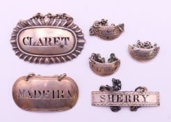 Two silver decanter labels, an unmarked sherry label and three silver cruet labels. The largest 5.