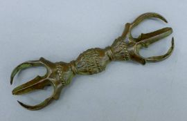 A Tibetan bronze vajra (dorje). 14 cm wide.