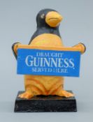 A cast iron 'Guinness' penguin. 16 cm high.