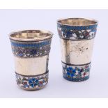 Two Russian silver and enamel vodka tots. The larger 5 cm high. 57.8 grammes total weight.