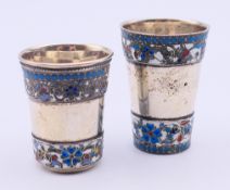 Two Russian silver and enamel vodka tots. The larger 5 cm high. 57.8 grammes total weight.