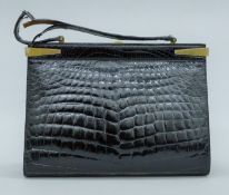 A Saks Fifth Avenue crocodile skin handbag. 30 cm wide.