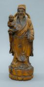 Two Chinese wooden figures. The larger 38 cm high.
