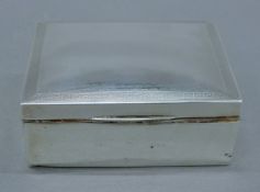 A silver cigarette box. 11 cm wide.