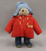 A vintage Paddington Bear toy in red duffle coat and blue Dunlop wellingtons. 48 cm high.