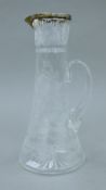 A silver rimmed cut glass ewer. 26 cm high.