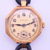 A 9 ct gold cased Rolex ladies' wristwatch. 2 cm diameter. 13.3 grammes total weight.