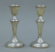 A pair of silver candlesticks. 14 cm high.