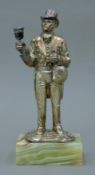 A silver model of a town crier on an onyx base. 21 cm high.