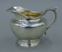 A silver cream jug. 12 cm long. 248.8 grammes.