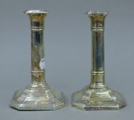 A pair of silver candlesticks. 14 cm high.