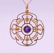 A 15 ct gold amethyst and seed pearl pendant on 9 ct gold chain.
