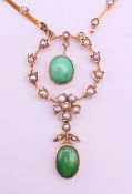 An Edwardian 9 ct gold, seed pearl and green stone pendant necklace.