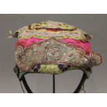 A 19th century Chinese embroidered child's hat. 20 cm wide.