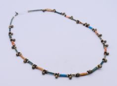 An ancient Egyptian multi-coloured faience and metal beaded necklace (re-strung).