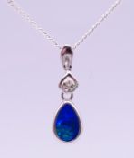 A silver mounted black opal pendant on chain. Pendant 2.2 cm high overall, chain 43 cm long.