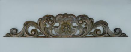 A 19th century carved oak green man pediment. 121.5 cm long.