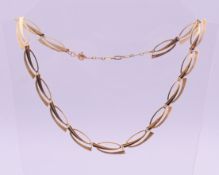 A 9 ct gold necklace. 47 cm long, 1 cm high. 14.1 grammes.