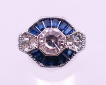An Art Deco style white metal dress ring. Ring size M/N.
