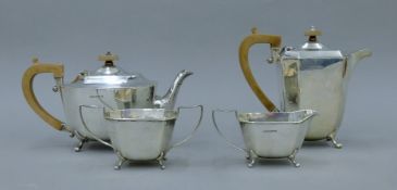 A four-piece silver tea set. The teapot 28 cm long. 1552.6 grammes.