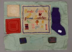 A vintage sampler and other needleworks. The sampler 21 x 21 cm.