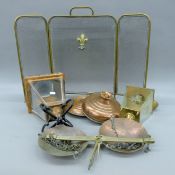 A quantity of brass and copper wares, including lanterns, copper warmers, a scale and a fire guard.