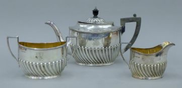 A matched three-piece silver tea set, the teapot with presentation inscription. The teapot 27.