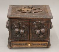 A late 19th/early 20th century Black Forest carved cigar box. 30 cm wide.