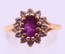 An 18 ct gold cluster ring. Ring size R/S. 3.8 grammes total weight.