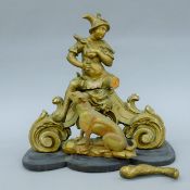 An 18th/19th century giltwood carving of a boy on an associated scroll carved base with an