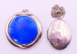 A silver and blue enamel compact and a silver locket on a silver chain.