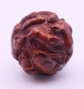 A ball carved with various animals. Approximately 4 cm diameter.