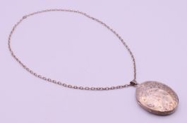 A large silver locket on a chain. Locket 5.25 cm high, chain 55 cm long. 33.6 grammes total weight.