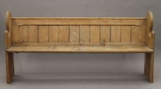 A Victorian pine church pew. 189 cm long.