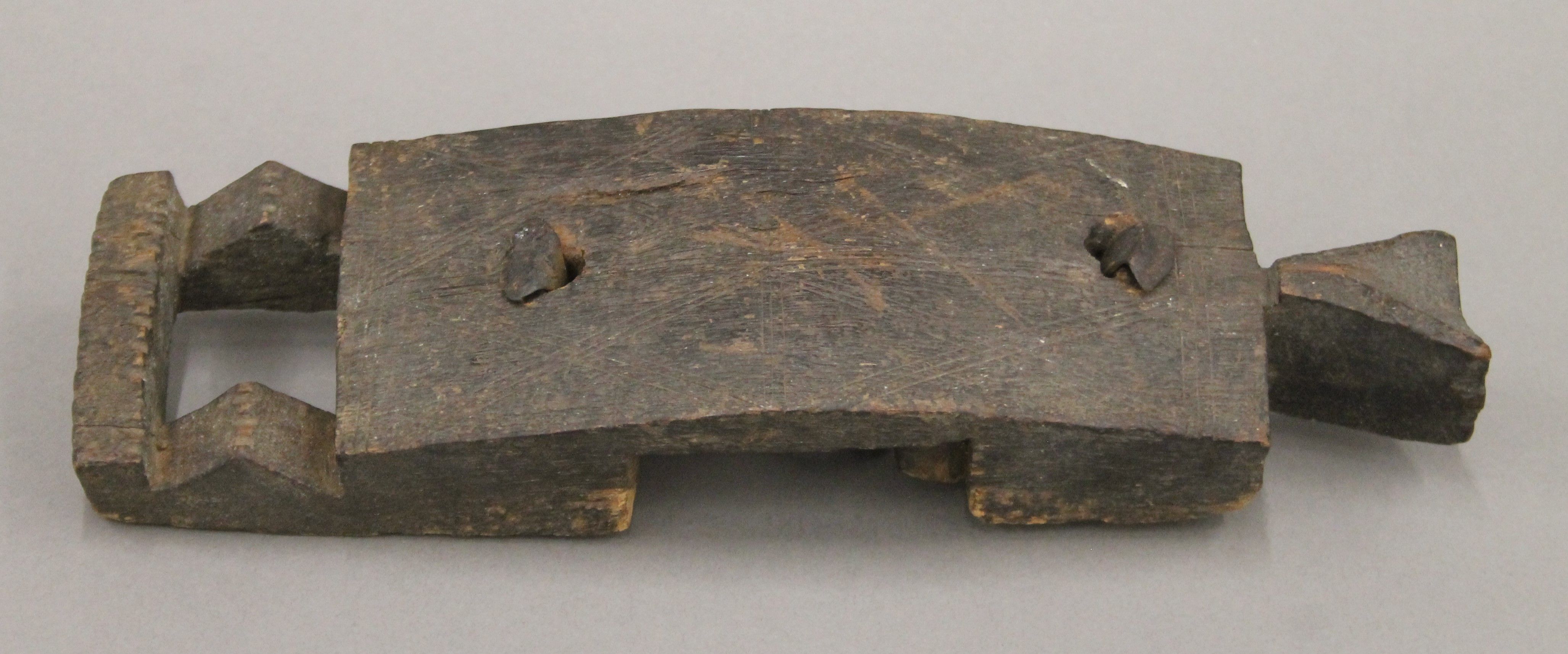An African tribal carved wooden door handle of figural form. 29 cm high.