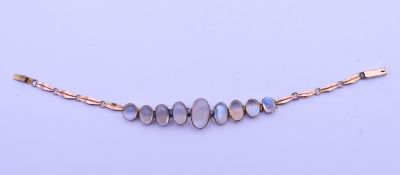 An unmarked gold and graduated moonstone bracelet. 16.5 cm long. 6.6 grammes total weight.