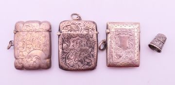 Three silver vestas and a silver thimble. Largest vesta 5.25 cm high. 68.4 grammes.
