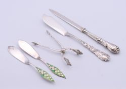A pair of silver tongs, a silver letter opener,