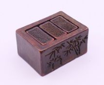 A Chinese set of three bronze seals housed in a bronze seal box. Each seal 1.