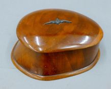 A wood box with cover made from a WWI aircraft propeller with metal Royal Flying Corps insignia to