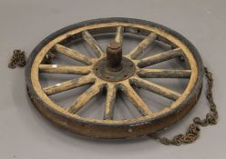 A rustic metal-mounted wooden cartwheel. 65 cm diameter.