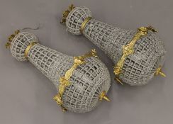 A pair of gilt metal and glass chandeliers. Each 64 cm high.