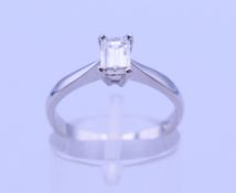 A platinum 0.5 carat emerald cut diamond solitaire ring. Ring size M/N. 3.7 grammes total weight.