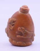 A tagua nut snuff bottle and stopper. 4.7 cm high.